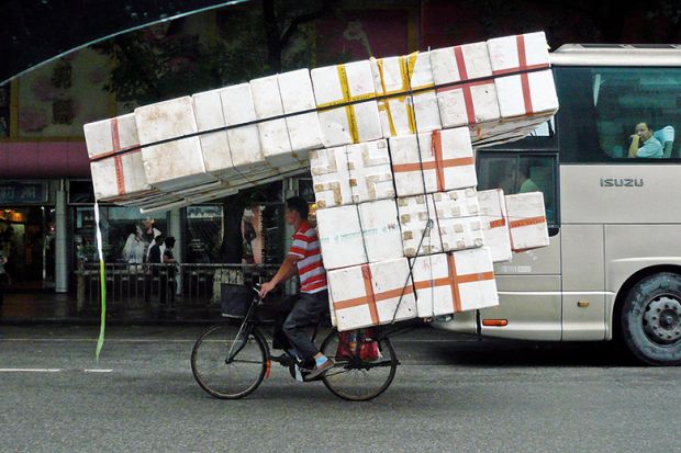 Man on bike laden with boxes illustrating mathematicians stockpiling Hagoromo chalk