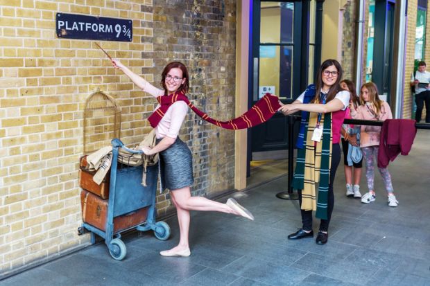 London UK - June 16 2016 Platform 9 three-quarter at Kings Cross Station with unidentified people. The platform is a fictive one from Harry Potter movies installed at Kings Cross for tourists