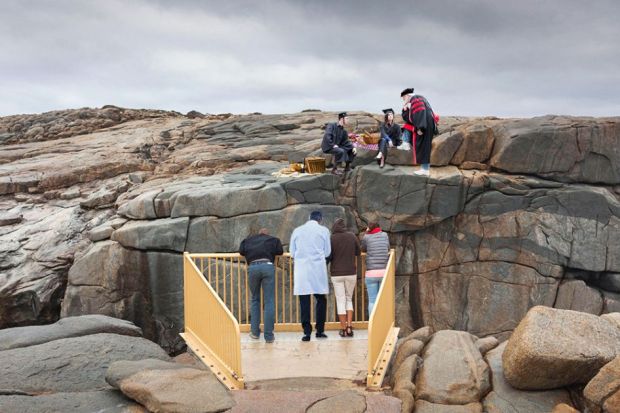 People looking across The Gap, Albany, Western Australia. On the other side, academics are having a picnic. To illustrate the difference in the remuneration of academics compared with those with specialist expertise.