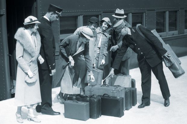 Train passengers identifying luggage for porter