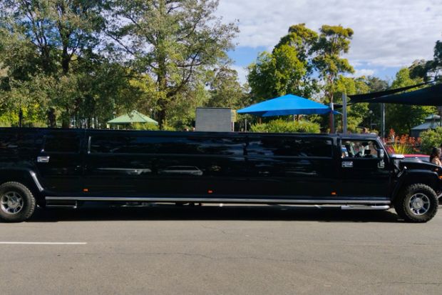 Luxury Stretch Hummer Limousine primarily black in colour, parked outside a community park in South Sydney, NSW Australia Luxury Stretch Hummer Limousine primarily black in colour, parked outside a community park in South Sydney, NSW Australia