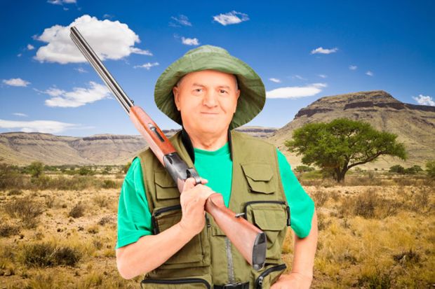 Male hunter holding shotgun