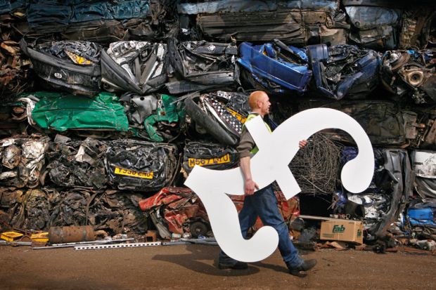 Male scrapyard worker carrying GBP pound sterling symbol