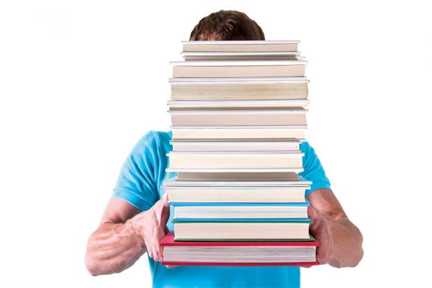 Man carrying pile of books with face hidden