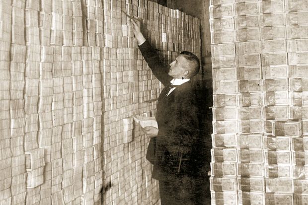 Man counting banknotes, Weimar Republic, Germany, 1923 Man counting banknotes, Weimar Republic, Germany, 1923