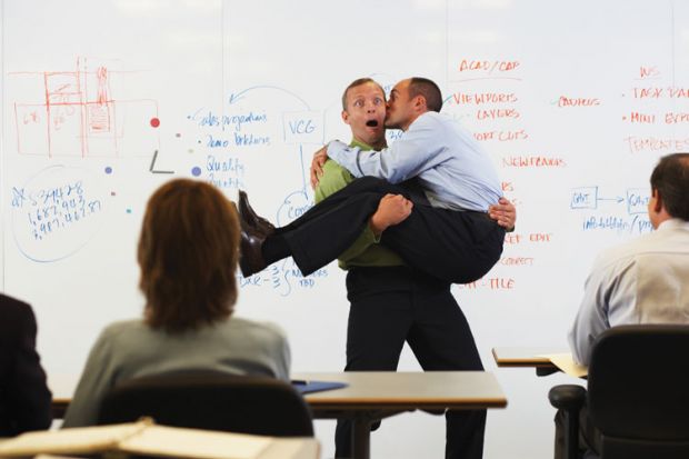 Man kissing man in front of classroom