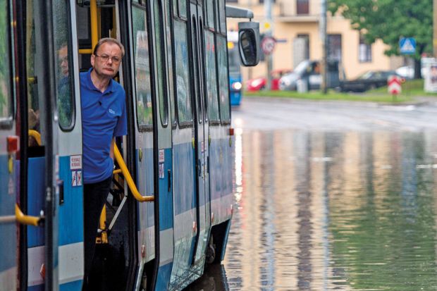 Man on tram stuck on flooded street, Wroclaw, Poland