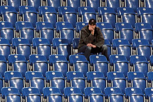 Man sitting alone in empty stadium