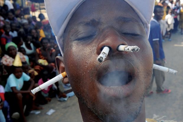 Man smoking cigarettes with ears and nostrils