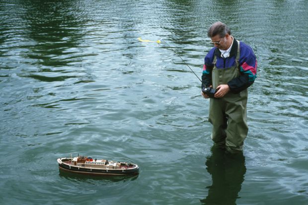 Man using remote-controlled boat