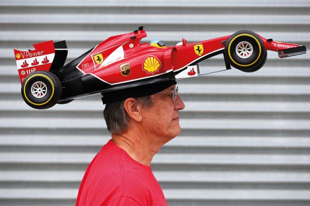 Man with F1 car on head