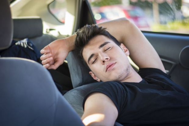 Man sleeping in a car