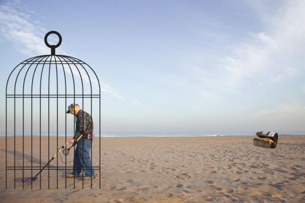 Man with a metal detector in a cage