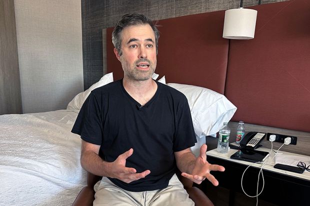 Mark Bray, a Rutgers assistant professor of history, waits in a hotel room in Newark, N.J., before a planned flight to Spain on Thursday, 9 October, 2025.