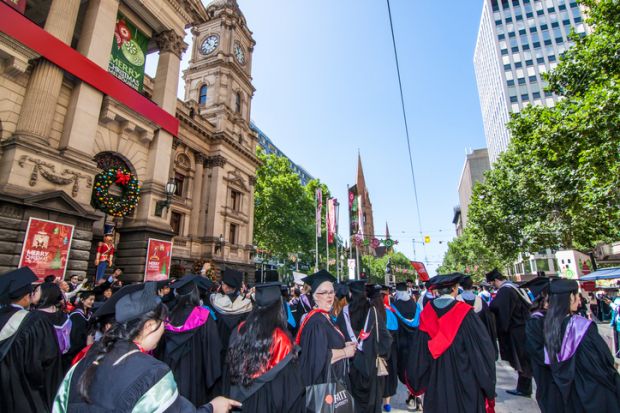 Melbourne, Australia - December 17, 2014 - RMIT university graduation day - the students walk along the Swanton St in Melbourne city for celebration day in graduation day