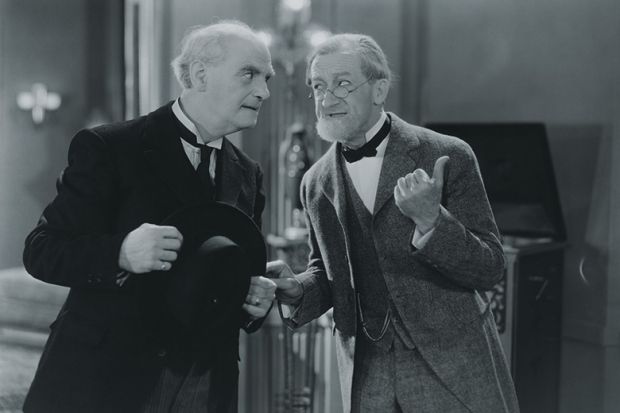 Two men gossiping Two men gossiping