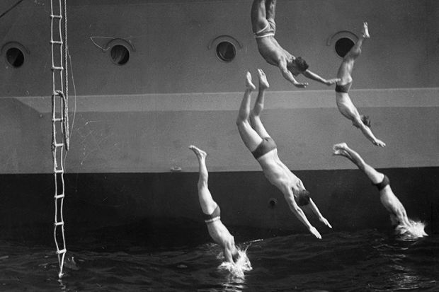Men diving from ship - 'jumping ship'. To illustrate that many UK universities are opting out of the nationally negotiated deal with Elsevier.