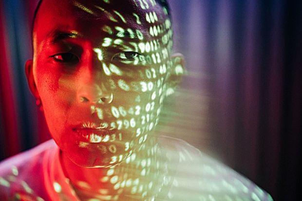 Numbers projected onto the face of an Asian man, symbolising metrics obsession