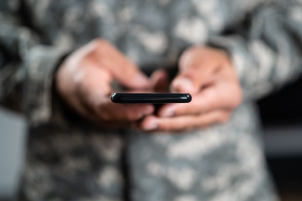 Military Soldier Smart Phone Espionage. Cyber War