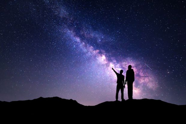 Two people staring into the night sky
