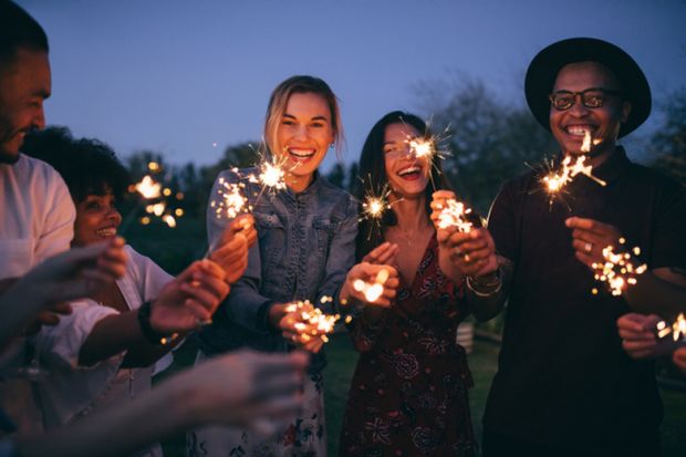A group of millennials with sparklers A group of millennials with sparklers