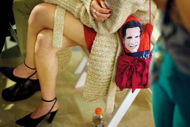 A student with a Mitt Romney mitten in her purse attends a debate watch party, 2012