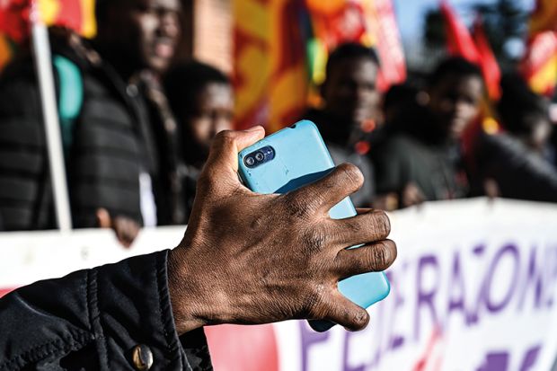 A migrant holds his mobile phone as members of anti-racism associations and migrants gather on Piazza della Repubblica in central Rome in December 2018 to protest the government’s decree restricting the right to asylum A migrant holds his mobile phone as members of anti-racism associations and migrants gather on Piazza della Repubblica in central Rome in December 2018 to protest the government’s decree restricting the right to asylum