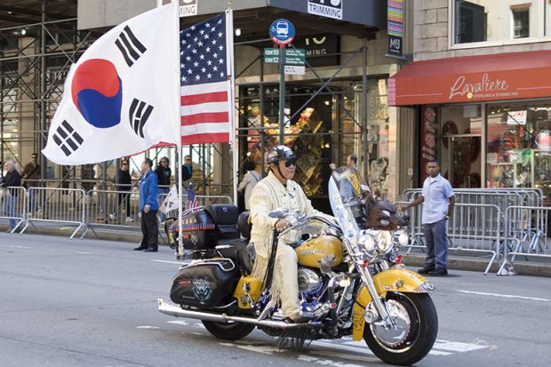 Korean Day Parade along Avenue of the Americas in New York, USA. Motorbike with American and Korean flags