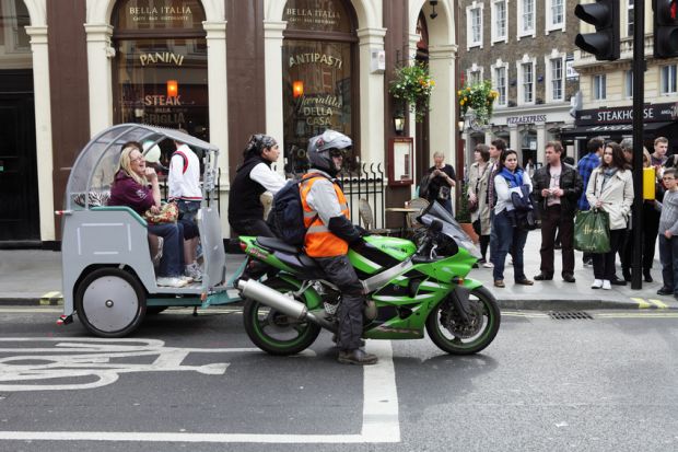 Motorbike and rickshaw at traffic lights Motorbike and rickshaw at traffic lights