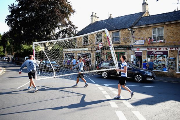 Players carry the goal posts away from the river following a football match, Bourton-on-the-Water, England. To illustrate a late surge in UK student visa refusals. Players carry the goal posts away from the river following a football match, Bourton-on-the-Water, England. To illustrate a late surge in UK student visa refusals.