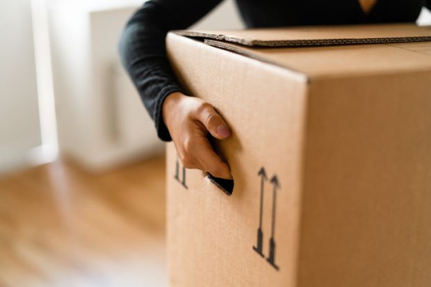 Person carrying moving boxes