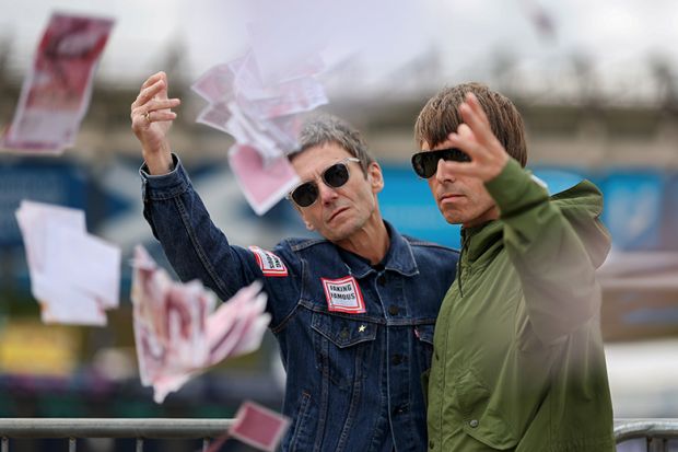Oasis lookalikes of Liam and Noel Gallagher throwing fake money pose for photographs. To illustrate universities using ‘dynamic pricing’ with overseas students offered thousands off fees. Oasis lookalikes of Liam and Noel Gallagher throwing fake money pose for photographs. To illustrate universities using ‘dynamic pricing’ with overseas students offered thousands off fees.