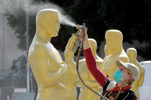 Woman spray paints giant Oscar statues