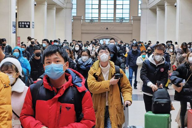 People wear face masks as they wait at Hankou Railway Station on January 22, 2020 in Wuhan, China