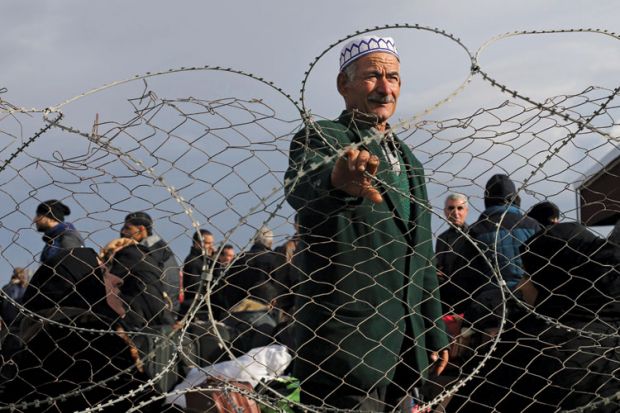 Palestinian man standing behind barbed fence, Gaza Strip, 2014 Palestinian man standing behind barbed fence, Gaza Strip, 2014