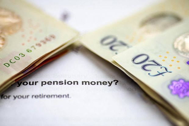 A close up of stacks of pound sterling bank notes on top of a pension planning letter. A close up of stacks of pound sterling bank notes on top of a pension planning letter.