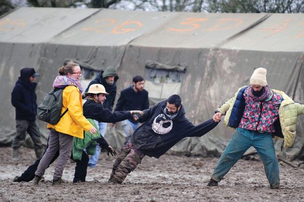 People help man stuck in mud at music festival, Notre-Dame-des-Landes, France