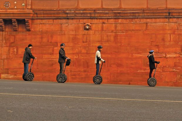 People riding Segways past Indian Home Ministry, New Delhi