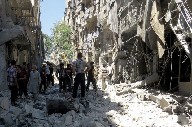People standing among rubble of destroyed buildings, Aleppo, Syria