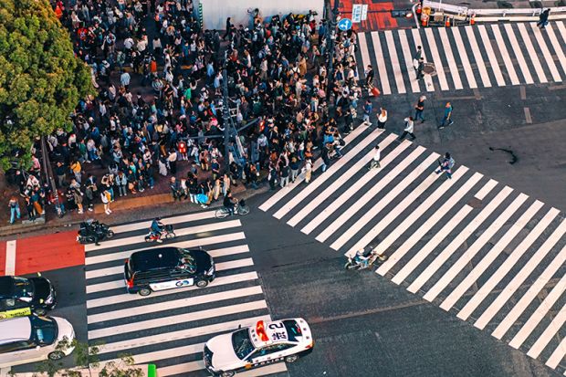 Crowd of people waiting to cross at Shibuya pedestrian crossing, Tokyo, Japan. To illustrate Asian students deciding on where to study, and whether they will switch to cheaper, safer and friendlier options closer to home. Crowd of people waiting to cross at Shibuya pedestrian crossing, Tokyo, Japan. To illustrate Asian students deciding on where to study, and whether they will switch to cheaper, safer and friendlier options closer to home.