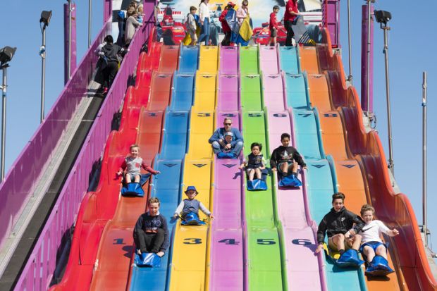 People enjoying a giant slide at the 2015 Royal Melbourne Show