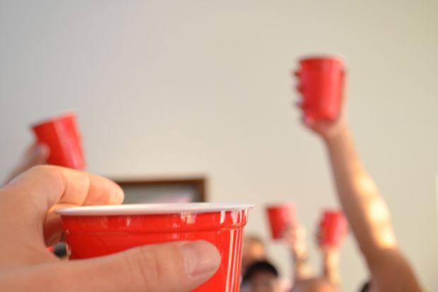 People toasting using red party cups