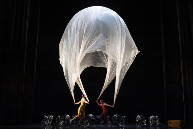 Performance with large sheet resembling umbrella