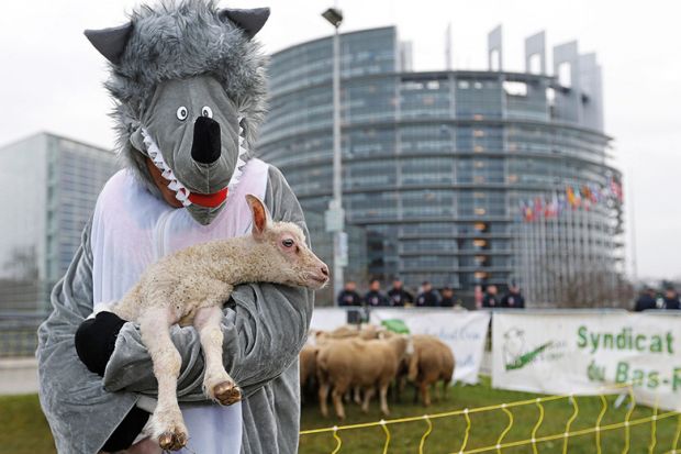 Person dressed as wolf and carrying lamb