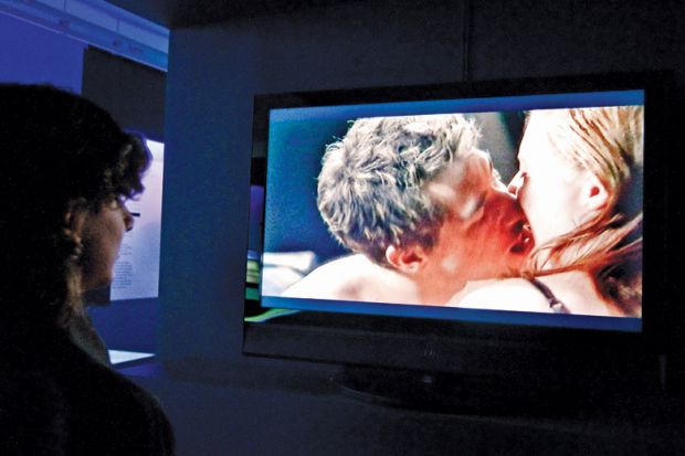 Person watching sex scene on television screen, Museum of Sex, New York City