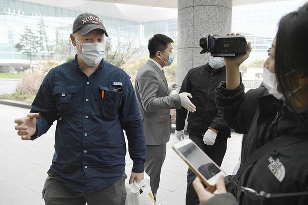 Peter Daszak (left), a member of the WHO team investigating the origins of the coronavirus pandemic, speaks at Wuhan’s airport in China on February 10, 2021, at the end of the WHO mission