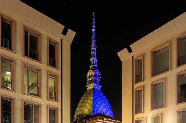 photo of mole antonelliana, monument of Turin, with the colors of the ukrainian flag. the flag was projected to demonstrate the solidity of the city to the ukraine invaded by russia.