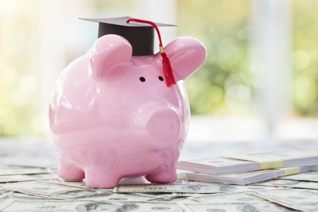 Piggy bank with a graduation mortar board cap concept for the cost of a college education
