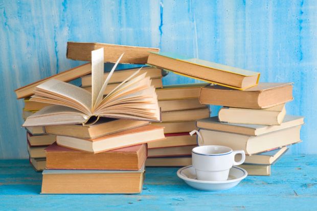 Piles of books with cup of tea Piles of books with cup of tea