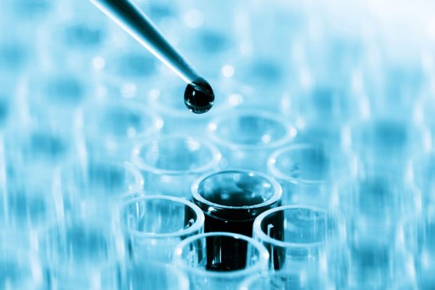 Pipette dripping liquid into test tube Pipette dripping liquid into test tube